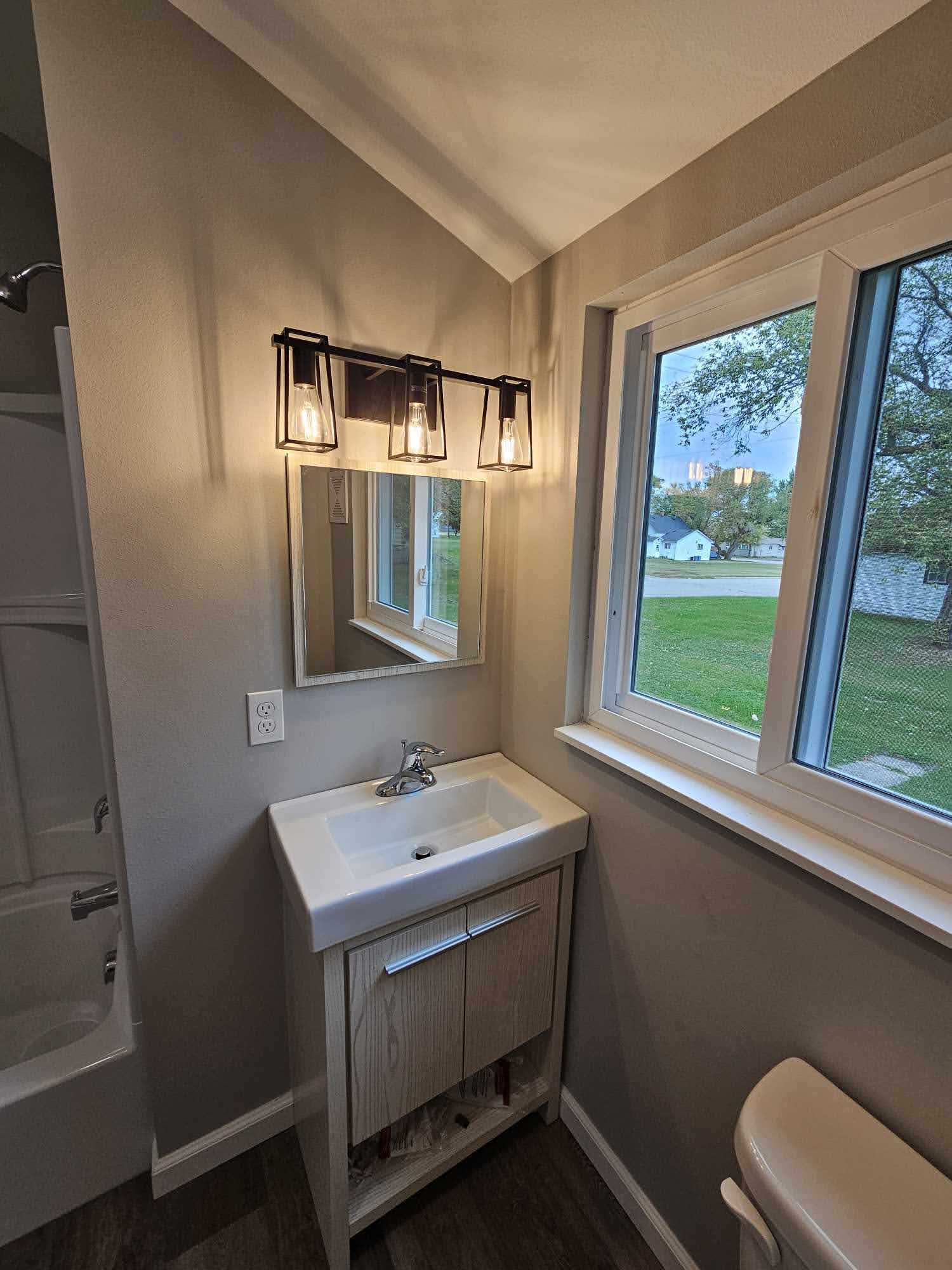 Bathroom vanity with modern light fixtures