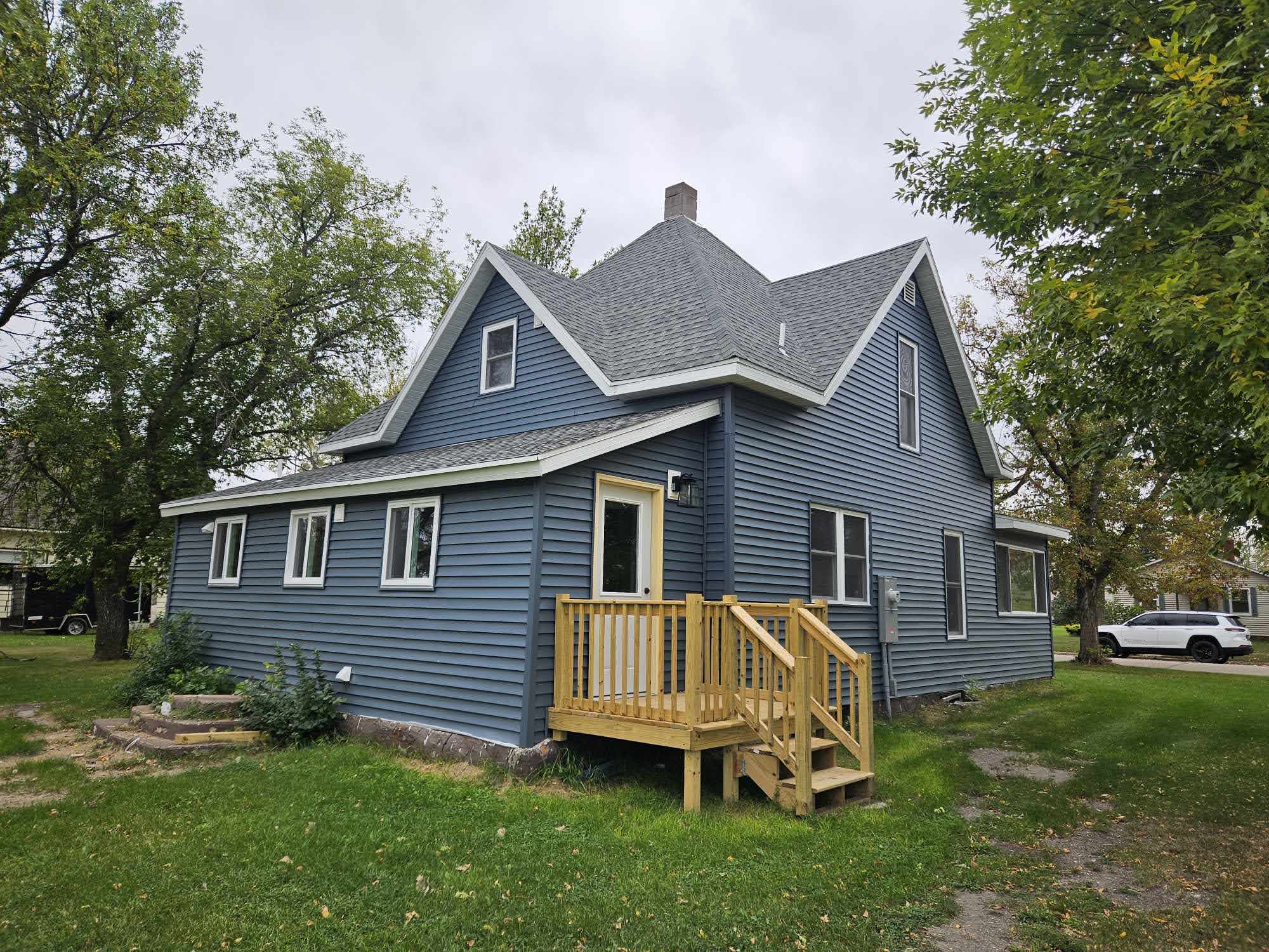 Back exterior with new deck and stairs
